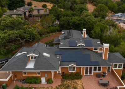 Over head East Facing Shot of Mission 435W Roof Mount Solar Panels and Exterior Wall Mounted SigenStor Batteries.